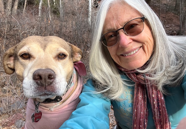 Photo of FOL Board Member Nancy Landau posing with a cute dog