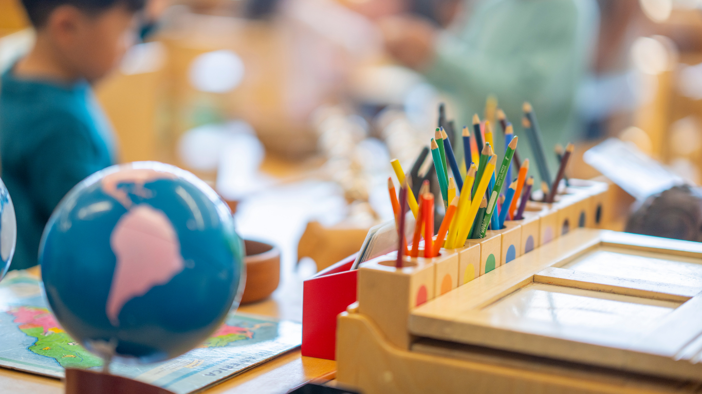 generic photo of a classroom with a globe and colored pencils